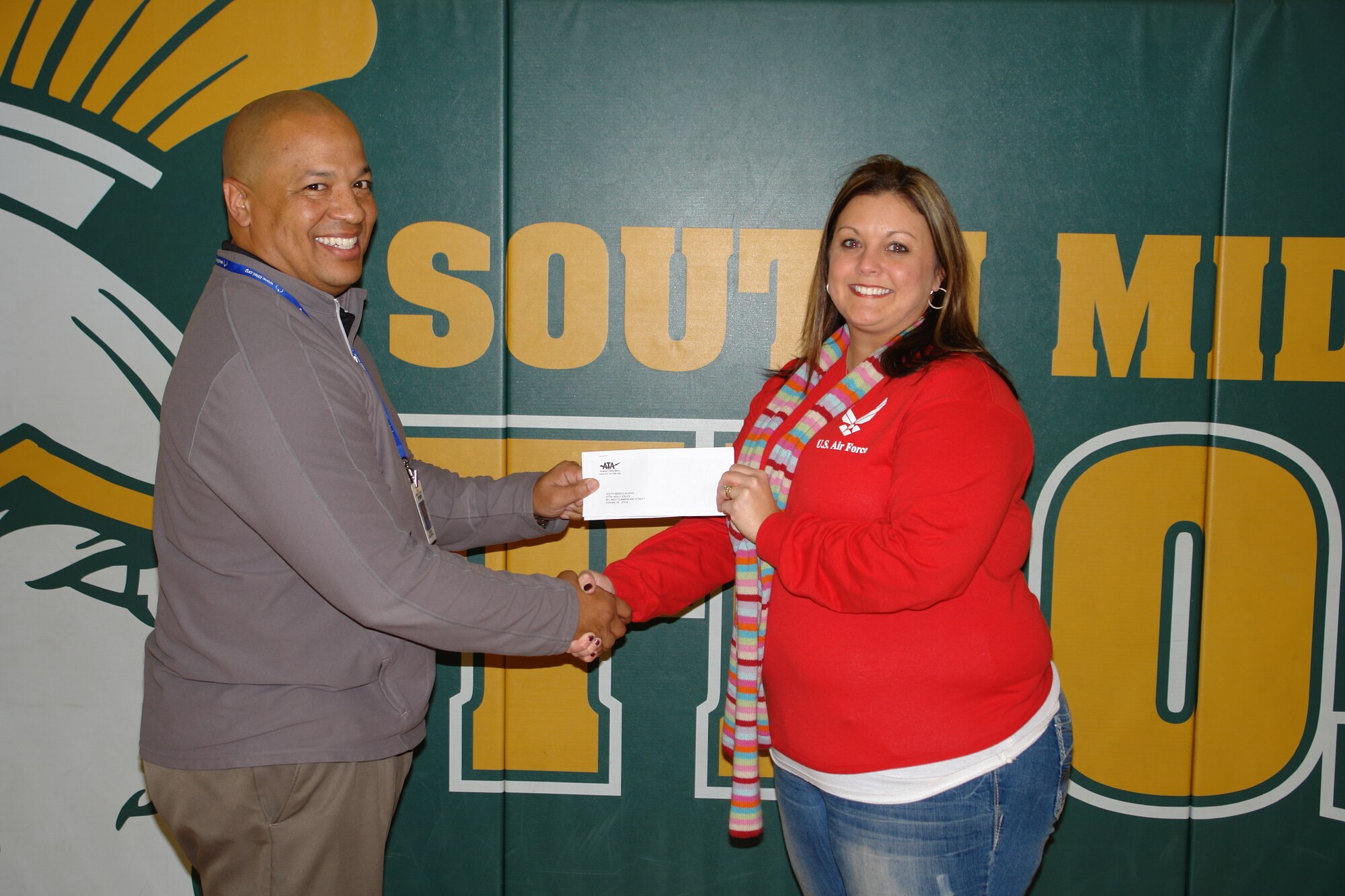 The Aerospace Testing Alliance (ATA) Employee and Community Activities Committee (E&CAC) made a donation of $150 to South Middle School to help in purchasing tables for the school’s outdoor classroom. Pictured left is Principal Derrick Crutchfield accepting the donation from E&CAC representative Andrea Stephens. (Photo by Laura Ore)