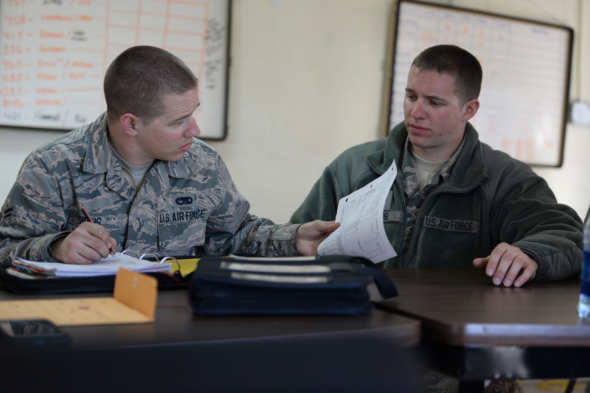 Airman 1st Class Nicholas Sirois and Staff Sgt. Michael Sirois review record documentation while particpating in Sentry Savannah 15-1, Feb 13, 2015, Savannah, Ga.  Sentry Savannah 15-1 is the Air National Guard's largest Fighter Integration, Air-to-Air, training exercise encompassing 4th and 5th generation aircraft.  (U.S. Air National Guard photo by Master Sgt. Ralph Kapustka/Released)