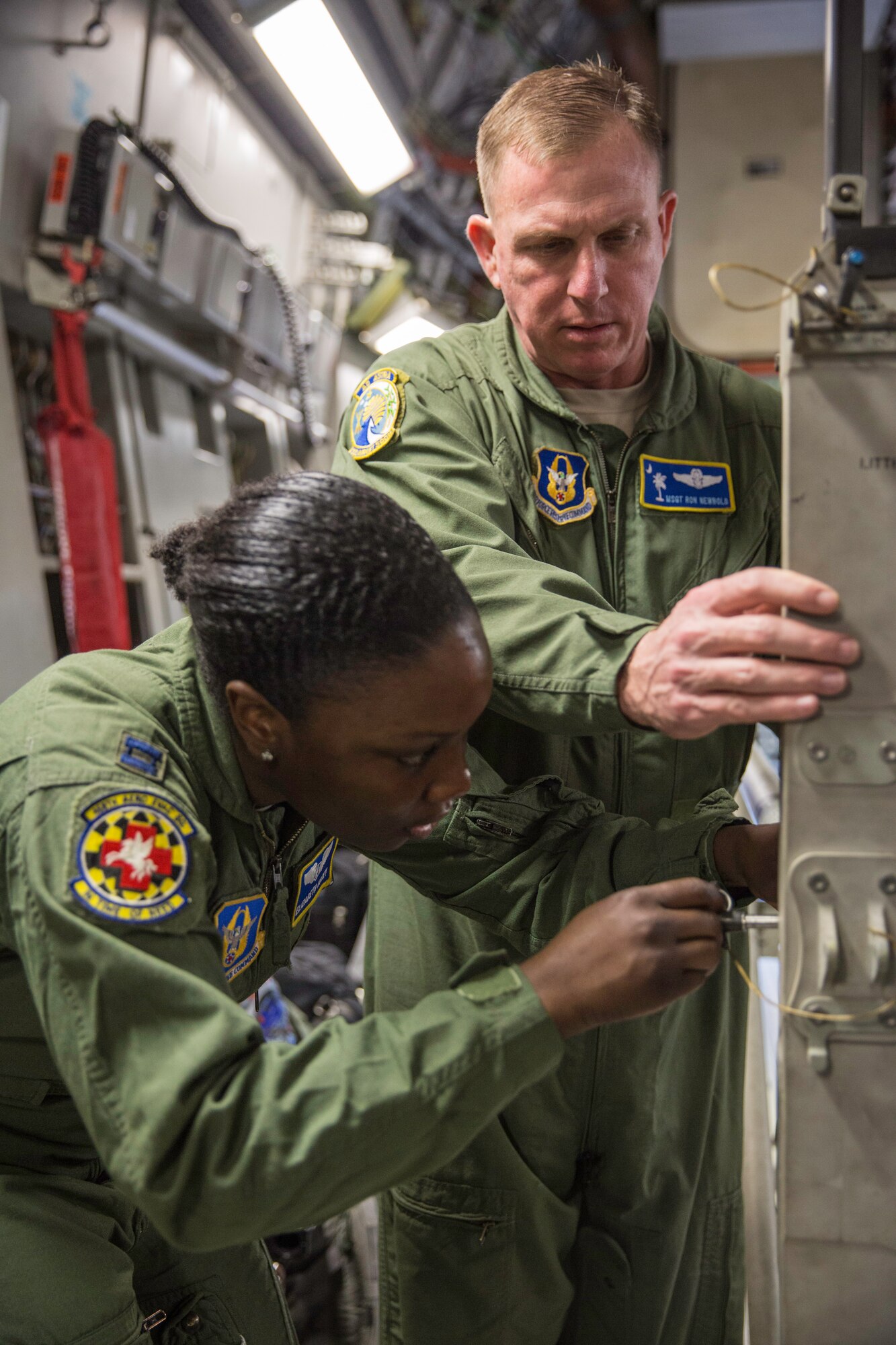 Master Sgt. Ron Newbold helps Capt. Elizabeth Kotey set up a litter stanchion Feb. 22, 2015 during a training mission in San Juan, Puerto Rico. The mission was part of a three day fly-away with Airmen from the 315th Airlift Wing at Joint Base Charleston, S.C. and aeromedical Airmen from the 459th Air Refueling Wing at Joint Base Andrews, Md. The training mission was a cost-effective means to accomplish currency items and evaluations for flight crew members and provided C-17 familiarization and proficiency training for aeromedical Airmen. Newbold is a loadmaster with the 300th Airlift Squadron and Kotey is a flight nurses with the 459th Aeromedical Evacuation Squadron (U.S. Air Force Photo/Tech. Sgt. Shane Ellis)