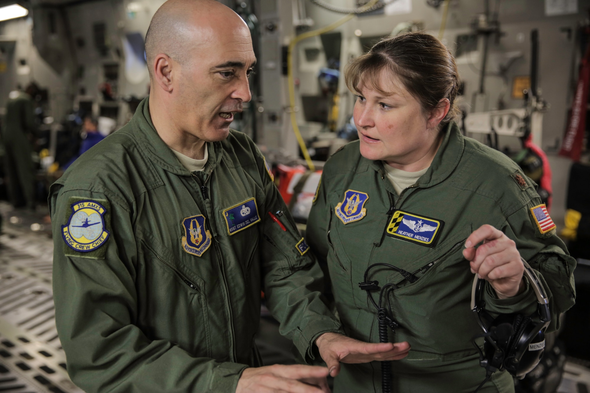 Master Sgt. Edwin Del Valle discusses the electrical system of the C-17 with Maj. Heather Menzies Feb. 22, 2015 during a training mission in San Juan, Puerto Rico. The mission was part of a three day fly-away with Airmen from the 315th Airlift Wing at Joint Base Charleston, S.C. and aeromedical Airmen from the 459th Air Refueling Wing at Joint Base Andrews, Md. The training mission was a cost-effective means to accomplish currency items and evaluations for flight crew members and provided C-17 familiarization and proficiency training for aeromedical Airmen. Del Valle is a flying crew chief with the 315th Aircraft Maintenance Squadron and Menzies is a Stan/Eval flight nurse with the 459th Operations Group (U.S. Air Force Photo/Tech. Sgt. Shane Ellis)
