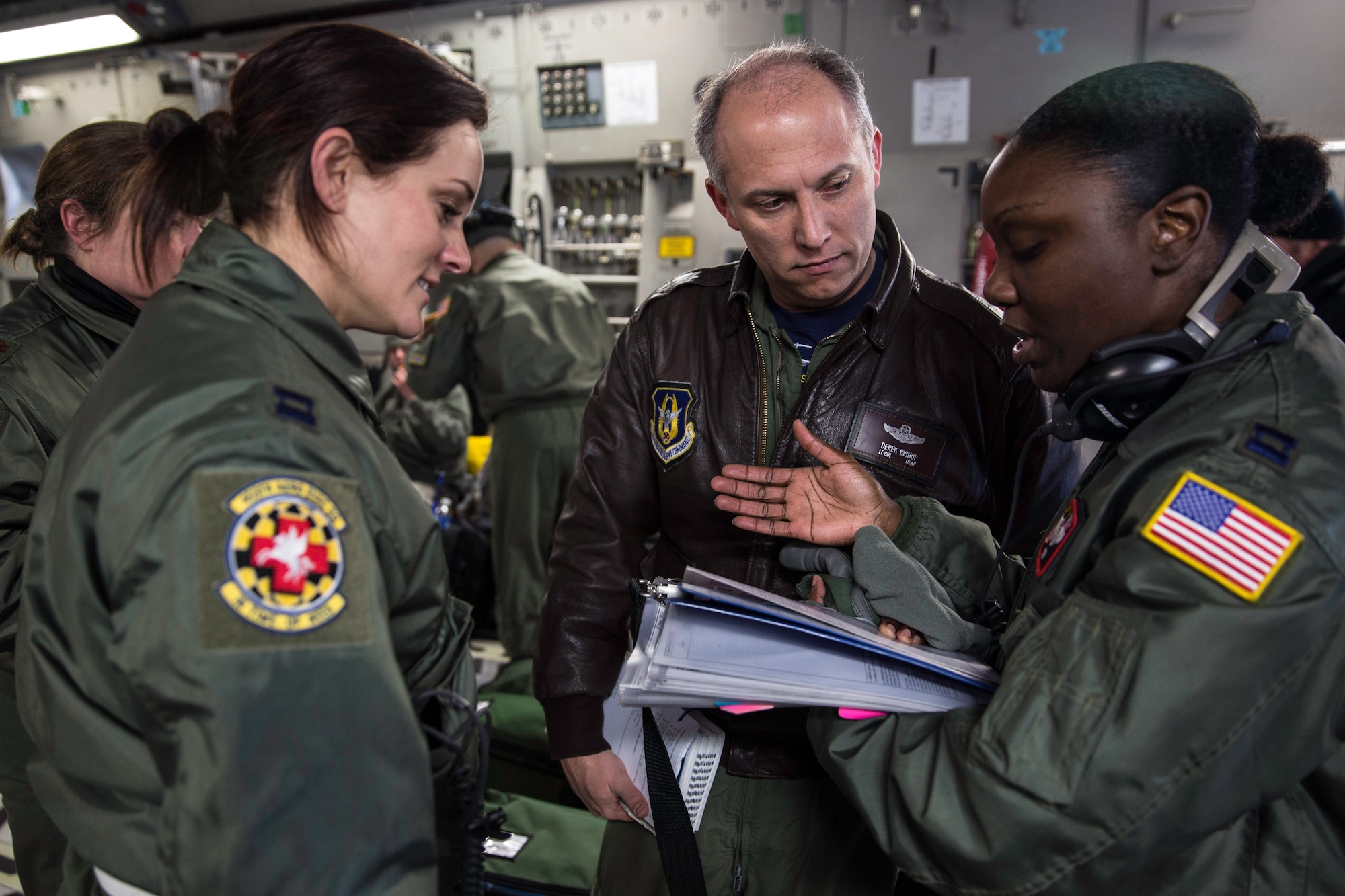 Lt. Col. Derek Bishop reviews the day’s aeromedical plan with Capt. Katie Pittinger and Capt. Elizabeth Kotey prior to taking flight Feb. 21, 2015 during a training mission in San Juan, Puerto Rico. The training mission was part of a three day fly-away with Airmen from the 315th Airlift Wing at Joint Base Charleston, S.C. and aeromedical Airmen from the 459th Air Refueling Wing at Joint Base Andrews, Md. The training mission was a cost-effective means to accomplish currency items and evaluations for flight crew members and provided C-17 familiarization and proficiency training for aeromedical Airmen. Bishop is the 315th AW safety chief and aircraft commander for the mission, and Pittinger and Kotey are both flight nurses with the 459th Aeromedical Evacuation Squadron (U.S. Air Force Photo/Tech. Sgt. Shane Ellis)