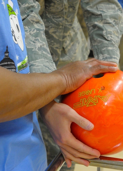 An Airman helps an athlete put his bowling ball in place at the D.C. Special Olympics Bowling Championship Feb. 25, 2015, in Hyattsville, Md. More than 50 Airmen from across the National Capital Region volunteered to support bowlers. (U.S. Air Force photo/Michael Martin)