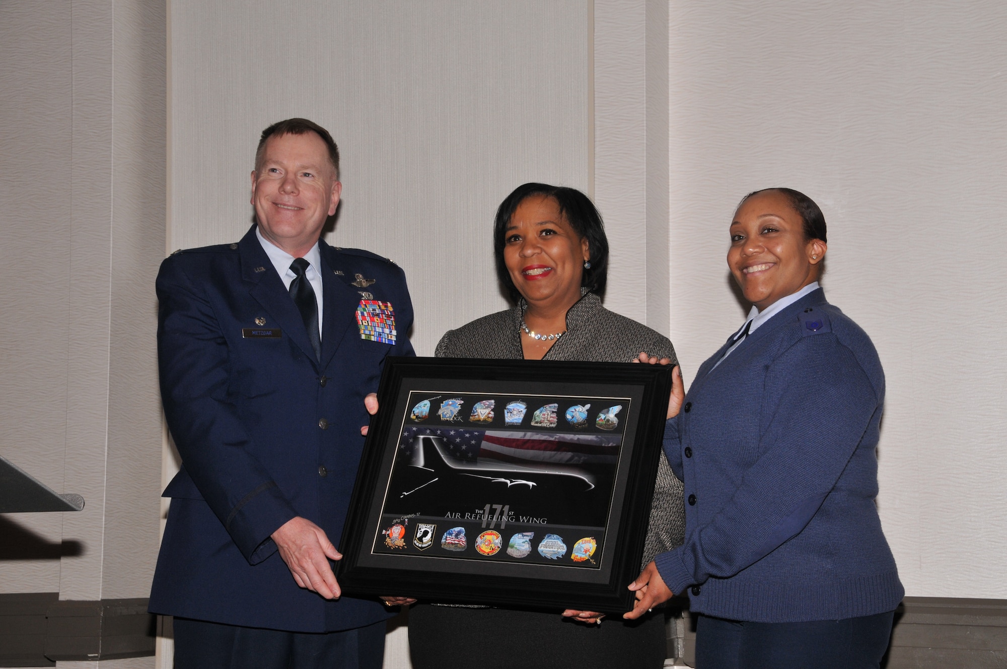 Keynote speaker Marcia M. Sturdivant, Ph. D, receives a gift from the 171st Air Refueling Wing Commander Col. Edward Metzgar and Technical Sgt. Shayla Pollard with recruiting as a thank you for her time and motival speech given at the 171st Air Refueling Wing's 32nd annual African-American Heritage Luncheon, Friday, Feb. 27, 2015, at the Pittsburgh Airport Marriott in Coraopolis, Pa. The event allowed the 171st ARW to celebrate "A Century of Black Life, History, and Culture" with the local community during African-American History Month. (U.S. Air National Guard photo by Airman 1st Class Allyson L Manners/ Released)