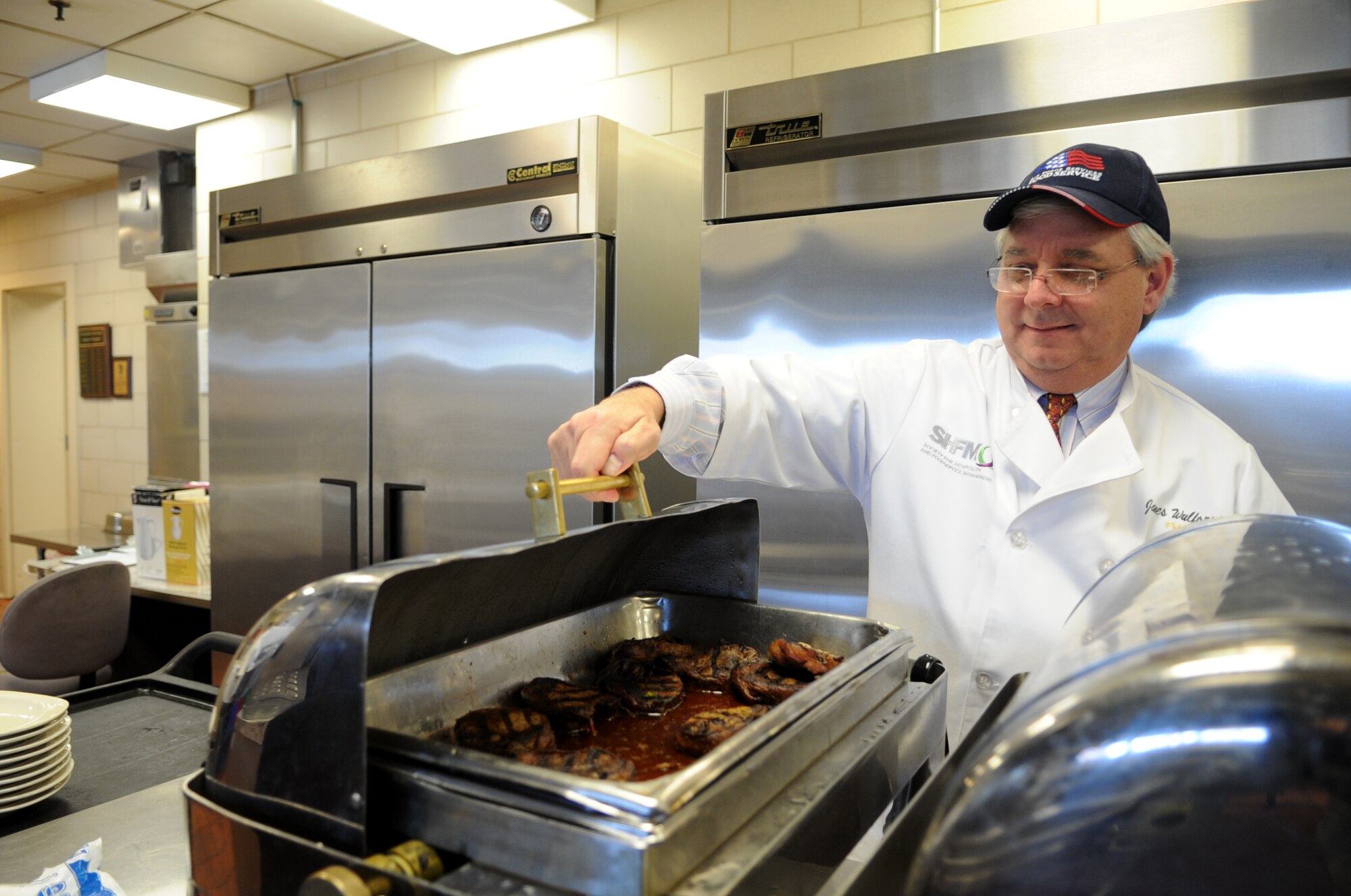 Jim Wulforst, Duke University dining service director, views the remaining filet mignon after evaluating the lunch service at the Freedom Hall Dining Facility on Joint Base Andrews, Md., Feb. 20, 2015.  (U.S. Air Force photo/Staff Sgt. Nichelle Anderson)