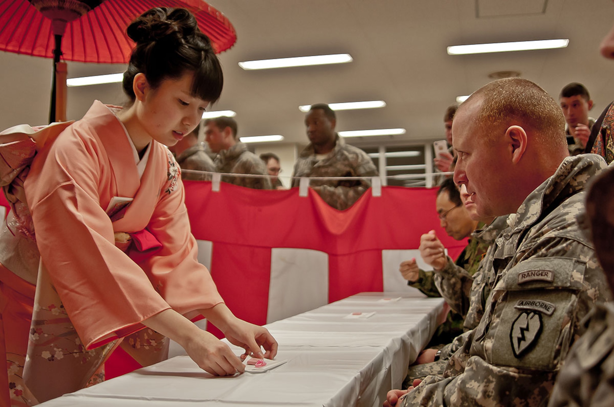 Capt. Kyle Soler, the commander of Blackfoot Company, 1st Battalion (Airborne), 501st Infantry Regiment, 4th Infantry Brigade Combat Team (Airborne), 25th Infantry Division, participates in a Japanese traditional tea ceremony with soldiers from the 27th Infantry Regiment, 5th Brigade, Northern Army, Japan Ground Self-Defense Force as part of a cultural night event during Exercise North Wind 2015 at Yausubetsu Training Area, Hokkaido, Japan, Feb. 11, 2015. Paratroopers with the Spartan Brigade are in Japan to participate in Exercise North Wind 2015, a two-week bilateral field training and command-post exercise, to increase combat readiness and interoperability amongst U.S. Army personnel and the JGSDF to respond to a broad range of crisis contingencies in the Asian-Pacific region. (U.S. Army photo/Sgt. Eric-James Estrada/Released)