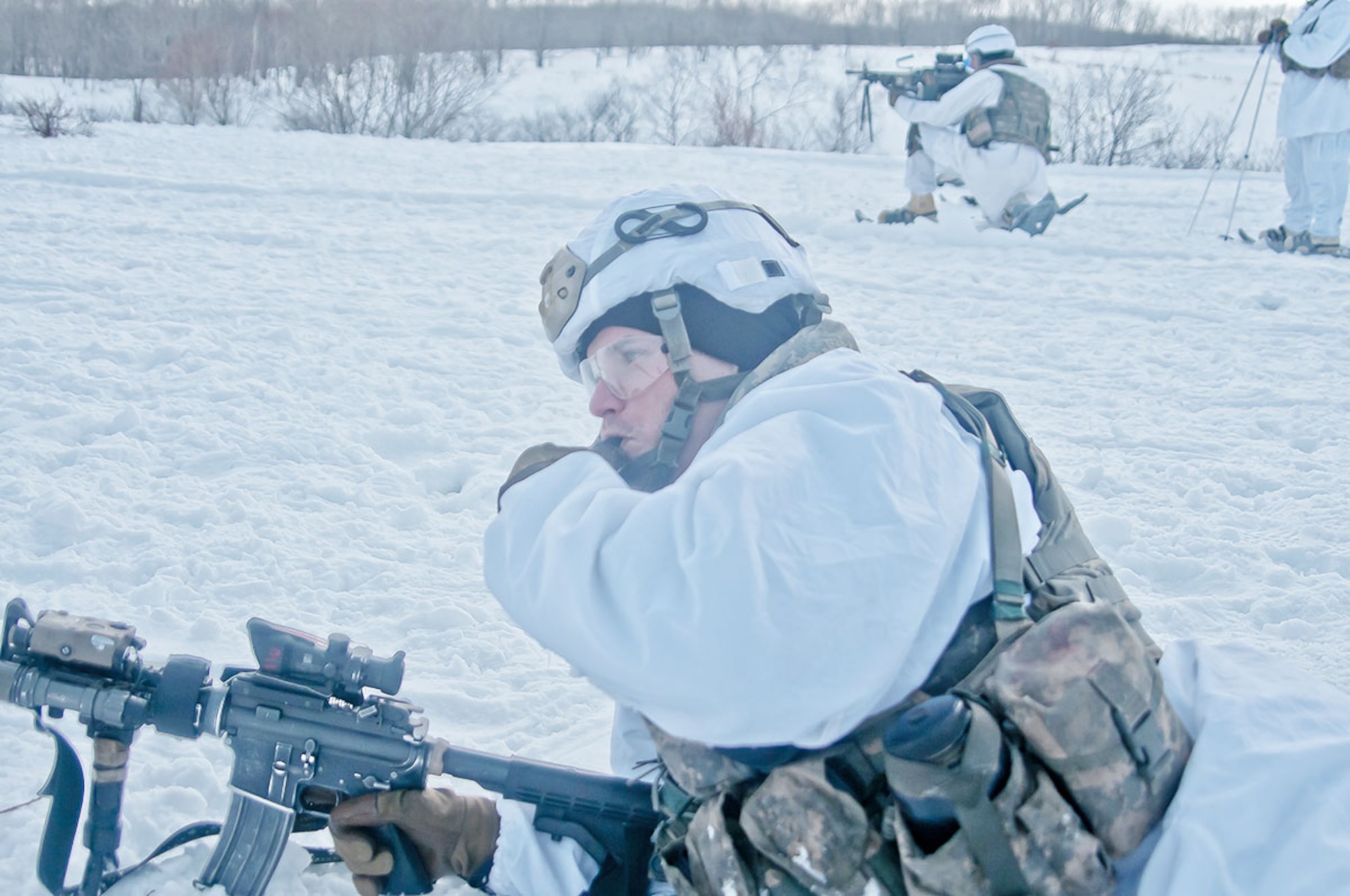 Staff Sgt. Carl Wright, a squad leader with U.S. Army Alaska’s 1st Battalion (Airborne), 501st Infantry Regiment, 4th Infantry Brigade Combat Team (Airborne), 25th Infantry Division, blows a whistle signaling the Japanese soldiers with the 27th Infantry Regiment, 5th Brigade, Northern Army, Japanese Ground Self Defense Force to advance from their position during a live fire exercise as part of Exercise North Wind 2015 at Yausubetsu Training Area, Hokkaido, Japan Feb. 11, 2015. Paratroopers with the Spartan Brigade are in Japan to participate in Exercise North Wind 2015, a two-week bilateral field training and command post exercise, to increase combat readiness and interoperability amongst U.S. Army personnel and the JGSDF to respond to a broad range of crisis contingencies in the Asian-Pacific region. (U.S. Army photo/Sgt. Eric-James Estrada/Released)