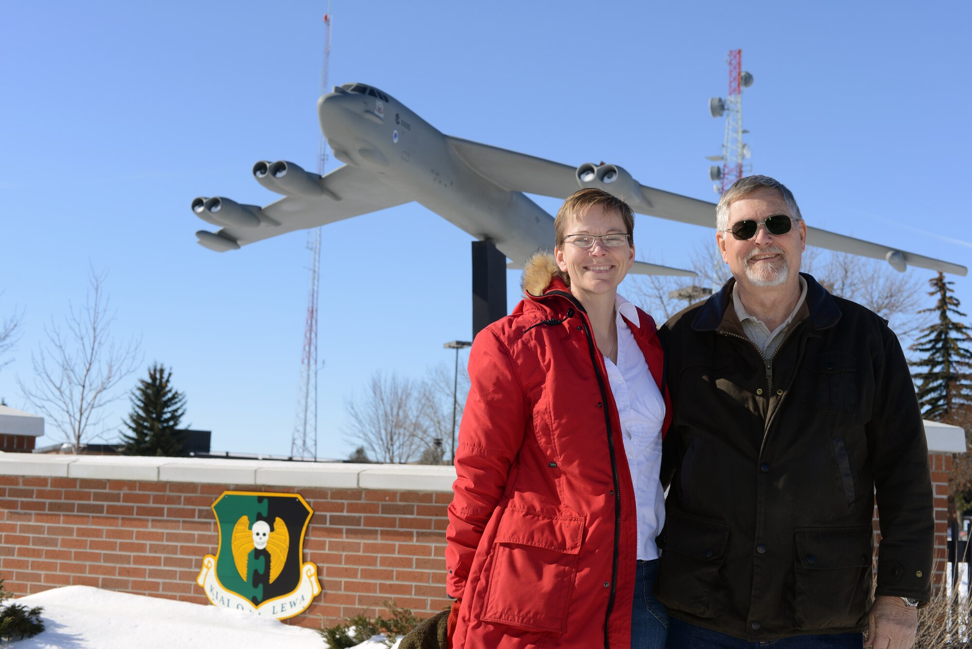 Maj. Nickole Lensgraf, 705th Munitions Squadron missile maintenance officer in charge of B-52 munitions, poses with her dad, Terry Hanscam on Minot Air Force Base, N.D., Feb. 27, 2015. Hanscam is a Vietnam veteran who tracked B-52s from the USS Goldsborough guided missile destroyer.  A B-52 from Minot Air Force Base is scheduled to fly over a ceremony commemorating the 50th anniversary of the Vietnam War March 2, 2015 at the Air Force Memorial in Washington D.C. (U.S. Air Force photo/Senior Airman Brittany Y. Bateman)    