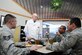 Art Ritter, Hennessey Trophy Award evaluator speaks with patrons at the Freedom Hall Dining Facility Feb. 20, 2015. Ritter was one of three evaluators assessing the DFAC in five categories: kitchen operations; serving and dining operations; training, personnel, and readiness; sanitation, repair and maintenance; and management. (U.S. Air Force photo/ Staff Sgt. Nichelle Anderson)