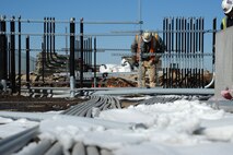 An LPR construction worker installs electric lines where an office will be in Hangar 1125, Feb. 24, at McConnell Air Force Base, Kan. The hangar is being built in preparation for the arrival of the KC-46A Pegasus. (U.S. Air Force photo by Airman 1st Class Christopher Thornbury)