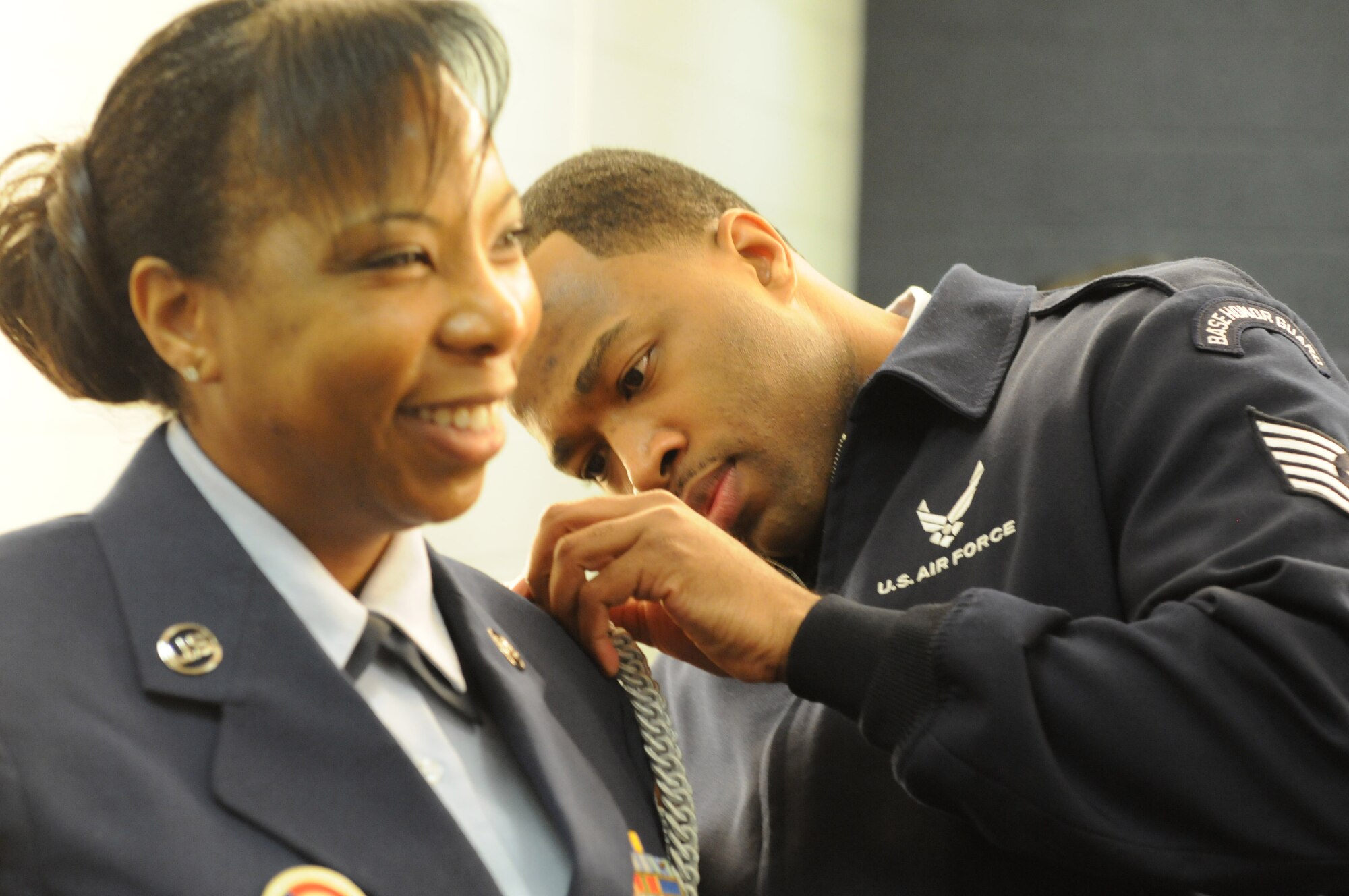 Tech. Sgt. Marcus Boykin helps Tech. Sgt. Jaqueline Constance with her Honor Guard uniform prior to presenting the colors during the Washington Wizards home game against the Golden State Warriors, Feb. 24. Both Boykin and Constance are D.C. Air National Guard participating in a community appreciation night honoring the DCANG.  (Air National Guard photo by Master Sgt. Craig Clapper)