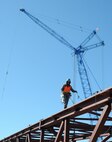 An LPR construction worker walks along a steel beam, Feb. 24, at McConnell Air Force Base, Kan. Hangar 1126 is being built in preparation for the arrival of the KC-46A Pegasus. (U.S. Air Force photo by Airman 1st Class Christopher Thornbury)
