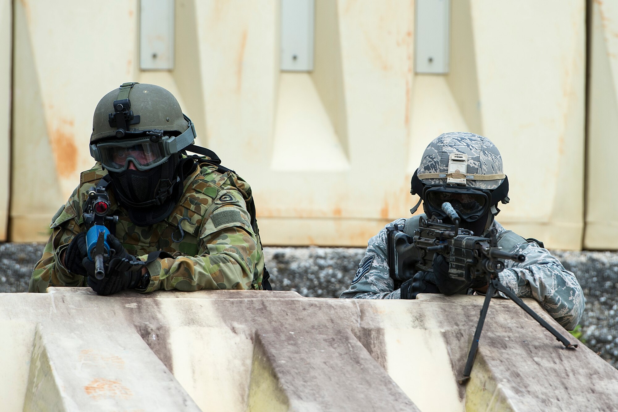 A U.S. Air Force Airmen from the 736th Security Forces Squadron, and a Royal Australian Air Force airfield defense guard, scan their sectors of fire while participating in a force on force combat scenario during Exercise Cope North 15, Feb. 23, 2015, at the Commando Warrior Pacific Regional Training Center, Andersen Air Force Base, Guam. Through training exercises such as Exercise Cope North 15, the U.S., Japan and Australia air forces develop combat capabilities, enhancing air superiority, electronic warfare, air interdiction, tactical airlift and aerial refueling. (U.S. Air Force photo by Tech. Sgt. Jason Robertson/Released)