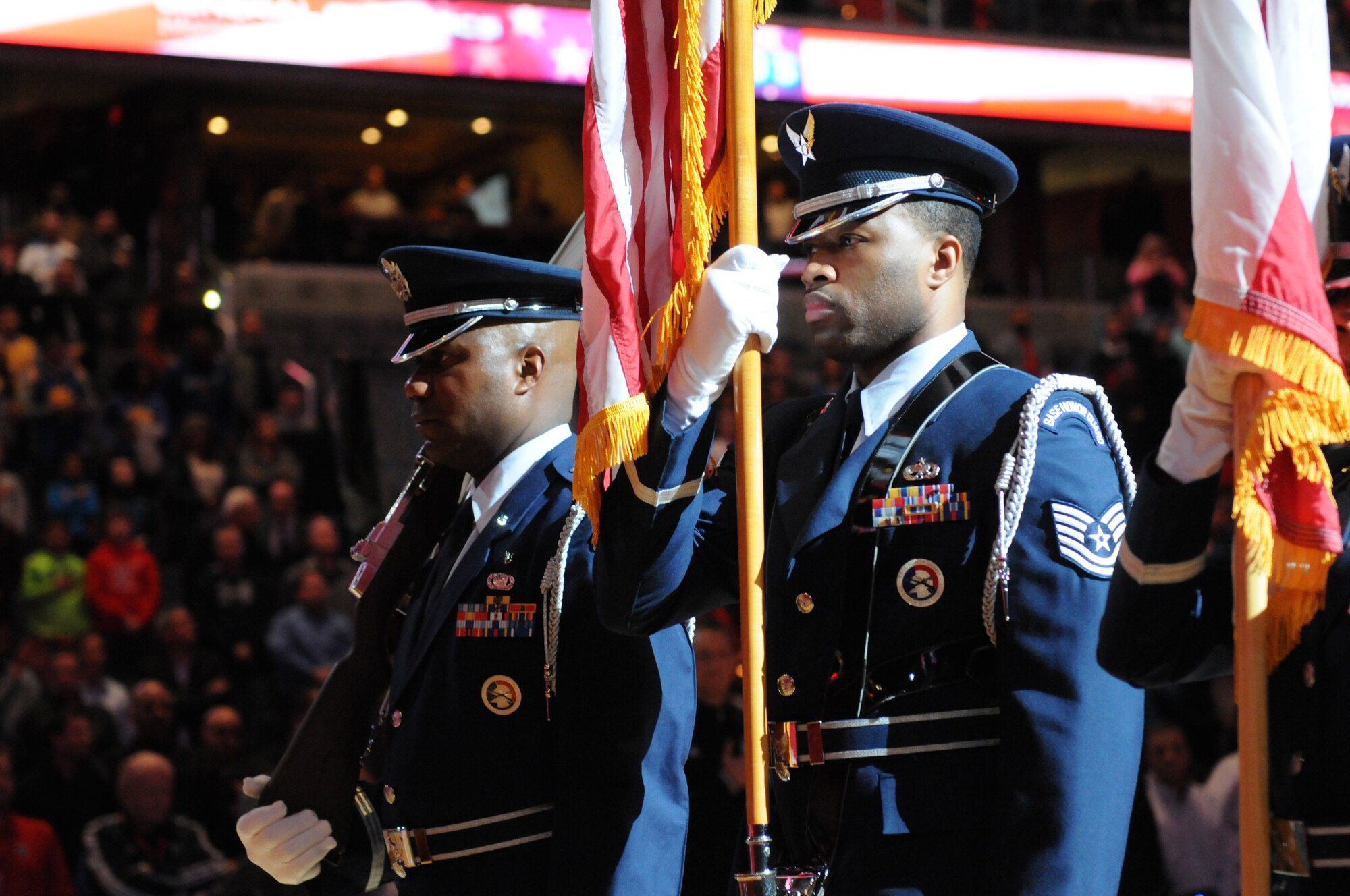 113th Wing Honor Guard members, Capt. Andre Slaughter and Tech. Sgt. Marcus Boykin, present the colors prior to the Washington Wizards home game against the Golden State Warriors, Feb. 24. The 113th Wing members were there as part of a community appreciation night honoring the D.C. Air National Guard during the Wizards game.  (Air National Guard photo by Master Sgt. Craig Clapper)