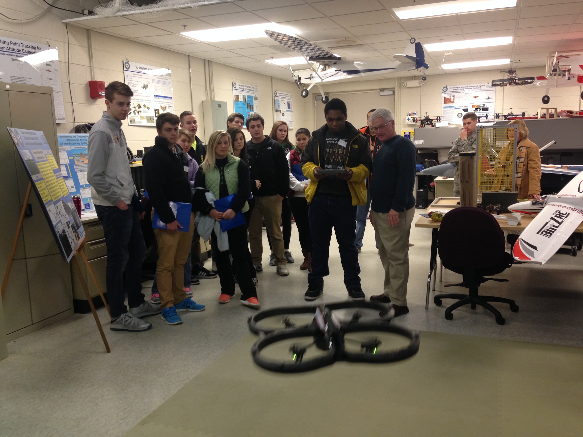 Rick Patton gives a student from Roger Bacon High School, Cincinnati, an opportunity to pilot a quadcopter within the Air Force Institute of Technology, Autonomous Navigation and Technology research center. On Feb. 24, students could participate in lab experiments, enjoy science and technology demonstrations and tour the AFIT campus to celebrate National Engineers Week. (Air Force photo by Bill Hancock