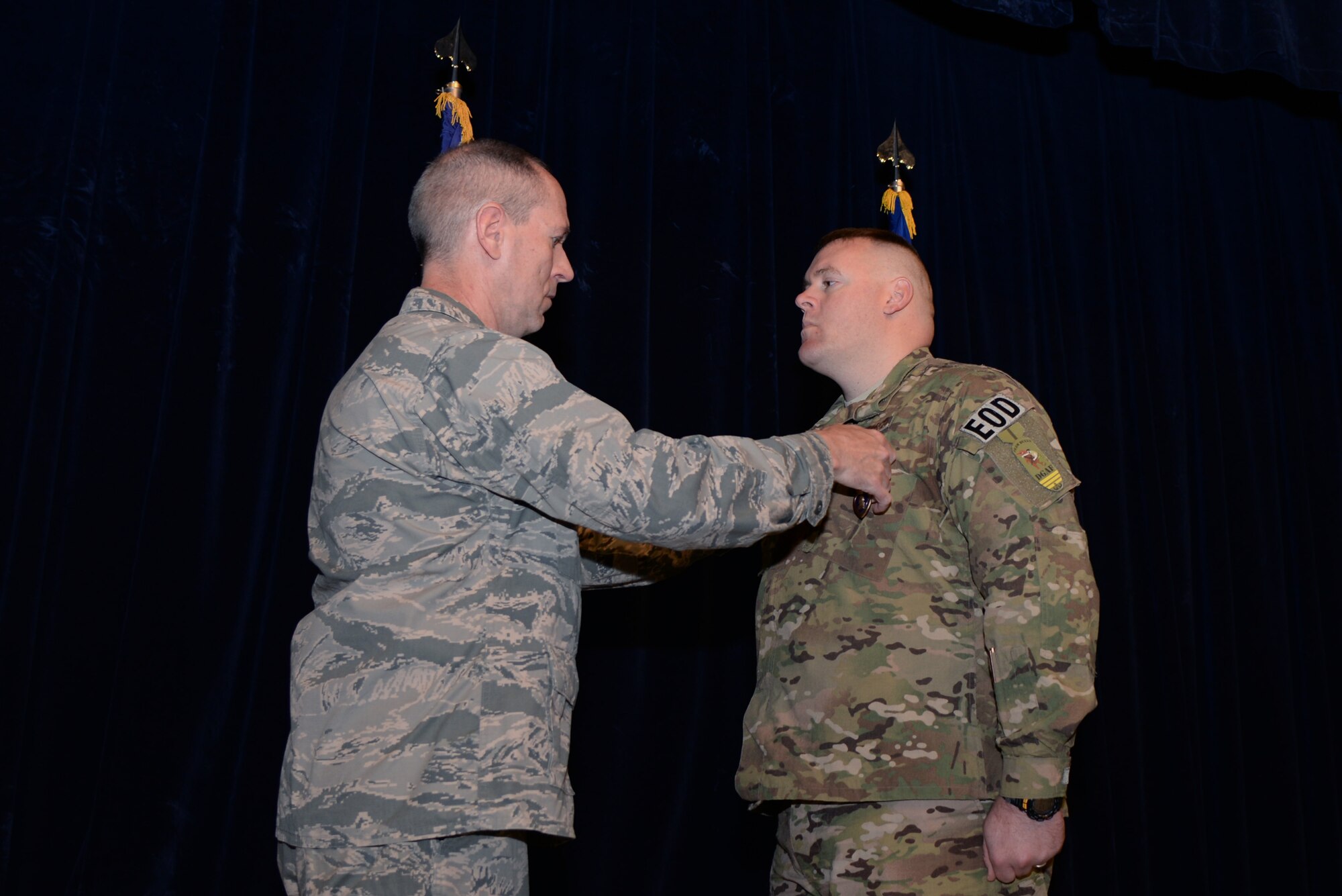 Tech. Sgt. Kristopher K. Parker receives the Purple Heart from Col. Markus Gmehlin, 59th Medical Support Group commander, Feb. 27, 2015 in the Wilford Hall Ambulatory Surgical Center auditorium, Joint Base San Antonio-Lackland, Texas. Parker, a member of the 59th MDW’s Airman Medical Transition Unit, received the distinguished medal for wounds received in action in May 2014 while deployed to Afghanistan. (U.S. Air Force Photo/Staff Sgt. Jason Huddleston)