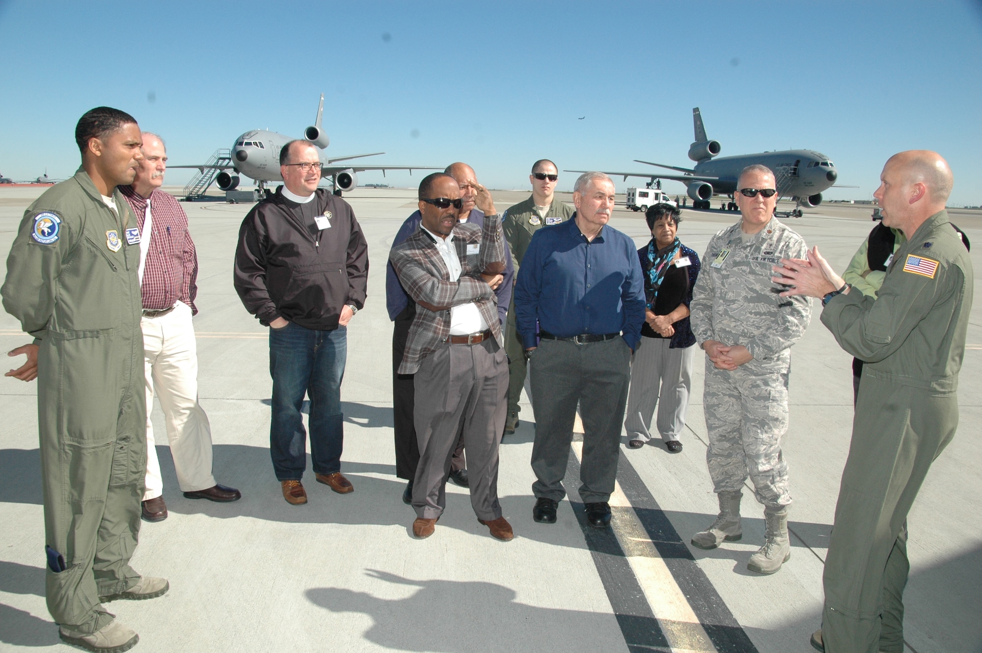 Lt. Col. Jeremy Reeves, right, 60th Air Refueling Squadron commander, and Staff Sgt. Alex Reynolds, left, 6th ARS KC-10 Extender flight engineer, brief a group of clergy and religious members on the capabilities of the jumbo jet Tuesday on the Travis Air Force Base, Calif., flightline. (U.S. Air Force photo by Jim Spellman)