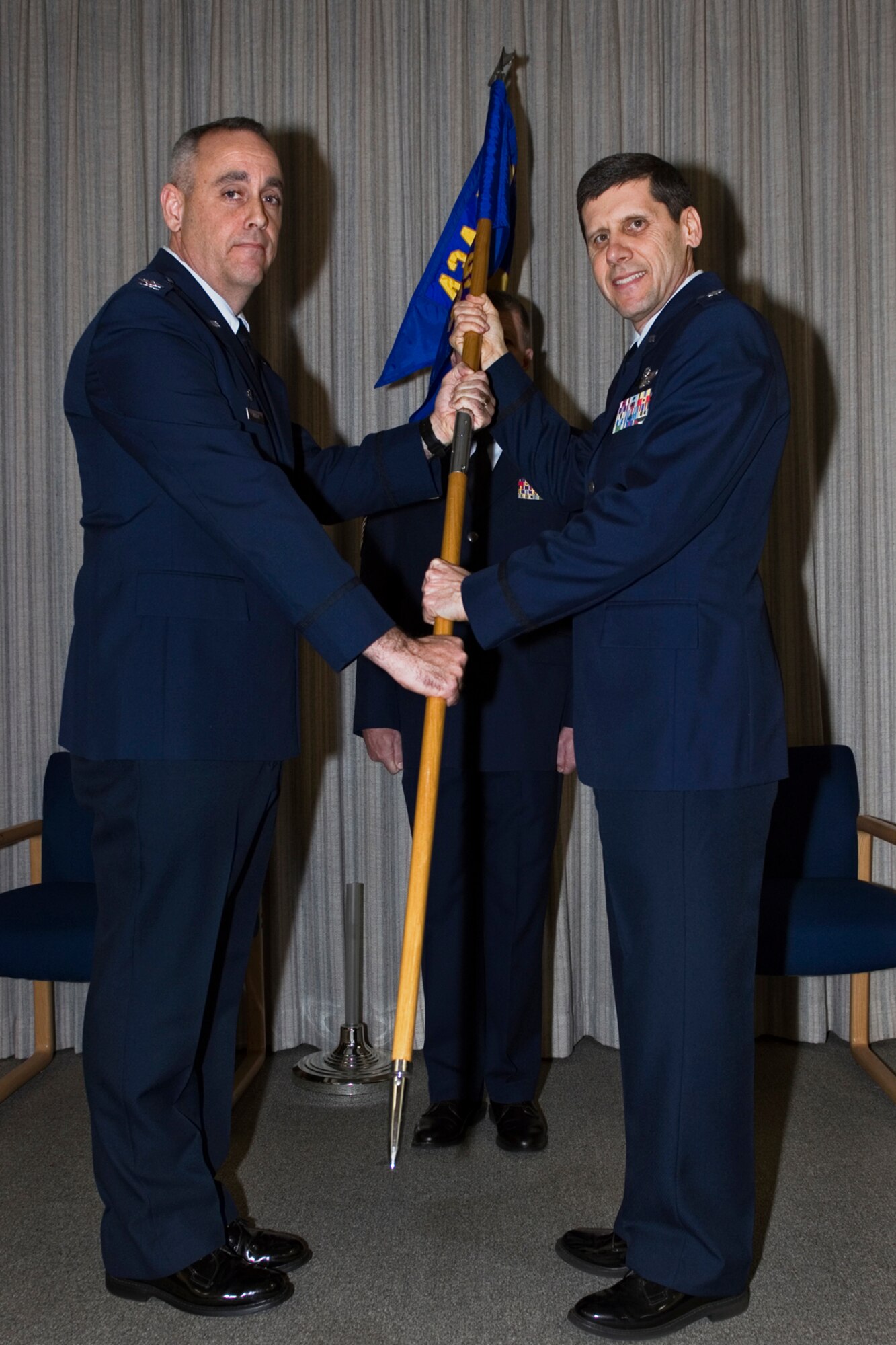 Lt. Col. Dave Schmitt, 434th Operations Support Squadron commander, receives the 434th OSS guidon from Col. Gerard Malloy, 434th Operations Group commander, during an assumption of command ceremony at Grissom Air Reserve Base, Ind., Feb. 6, 2015. Schmitt came to Grissom March 2013 as a 74th Air Refueling Squadron operations planner and has been the 434th OSS commander fill-in since October 2014. (U.S. Air Force photo/Tech. Sgt. Benjamin Mota)