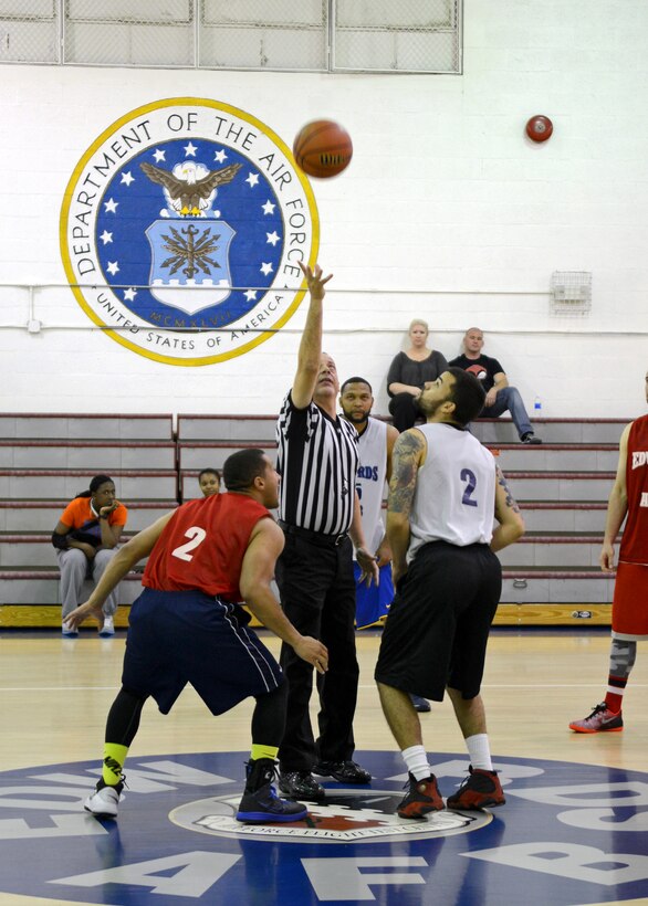 A tip off begins the Feb. 18 All-Star basketball game held at the Rosburg Fitness Center. The final score of the game was East 81- West 71. (U.S. Air Force photo by Jet Fabara)