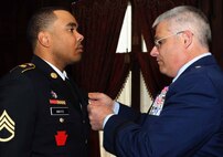 Brig. Gen. Tony Carrelli, Deputy Adjutant General-Air, Pennsylvania National Guard, Joint Force Headquarters at Fort Indiantown Gap, Pennsylvania, bestows the Major Octavius V. Catto Medal upon Staff Sgt. Melvyn L. Mayo Jr., Medical Battalion Training Site instructor, Fort Indiantown Gap, Feb. 21, 2015, at The Union League of Philadelphia, Philadelphia, Pennsylvania. The award bears the name of the Civil War-era African American leader and civil rights martyr from Philadelphia and is awarded to Guardsmen who display exemplary service and community support. (U.S. Air National Guard photo by Tech. Sgt. Andria J. Allmond/Released)