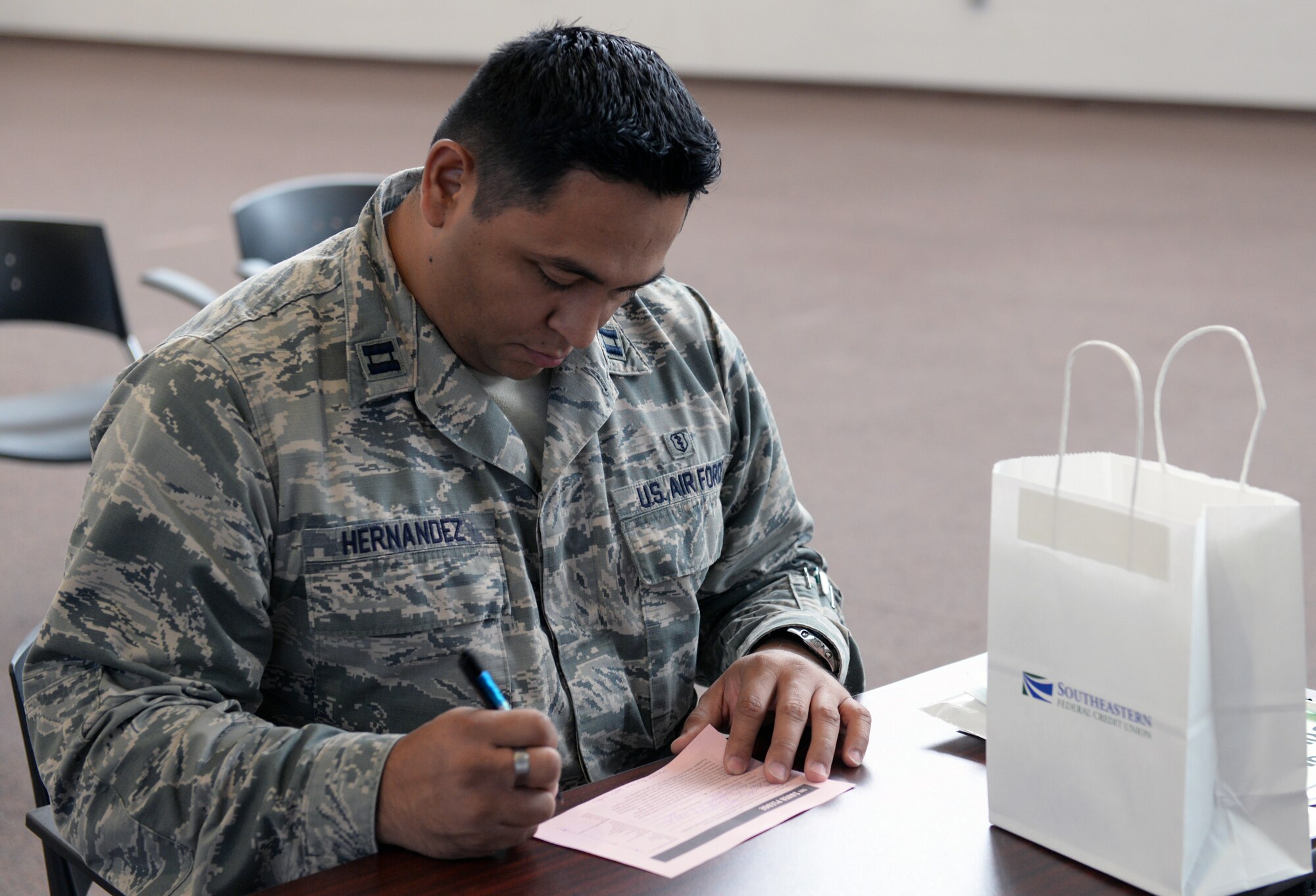 U.S. Air Force Capt. Alex Hernandez, 23d Medical Group family practice doctor, fills out the saver pledge at the Home Buying and Selling Seminar Feb. 18, 2015, at Moody Air Force Base, Ga. Taking the pledge allows Department of Defense card holders to receive information about saving money, reducing debt and building wealth with www.MilitarySaves.org. (U.S. Air Force photo by Airman Greg Nash/Released) 