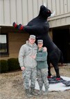 Staff Sgt. Erik Beagle and Senior Airman Rebekah Beagle pose in front of the Prime BEEF statue in the 22nd Civil Engineer Squadron complex, Feb. 27, 2015, at McConnell Air Force Base, Kan. The Beagles, who are both in the 22nd CES, have been married for almost two years and are preparing to deploy together. Erik is a facility systems flight electrician and Rebekah is an emergency management logistics journeyman. (U.S. Air Force photo by Senior Airman Victor J. Caputo)