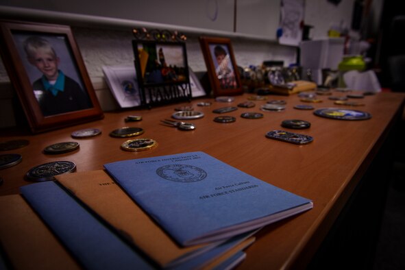 Air Force Instruction books lay on a book shelf in the office of Master Sgt. Etienne Tousignant, 786th Force Support Squadron career assistance advisor, at Ramstein Air Base, Germany, Feb. 11, 2015. After a path on a downward spiral, Tousignant was able to use his life experiences as an example of resilience and set his wingmen on the right path as a career advisor. (U.S. Air Force photo/Senior Airman Nicole Sikorski)
