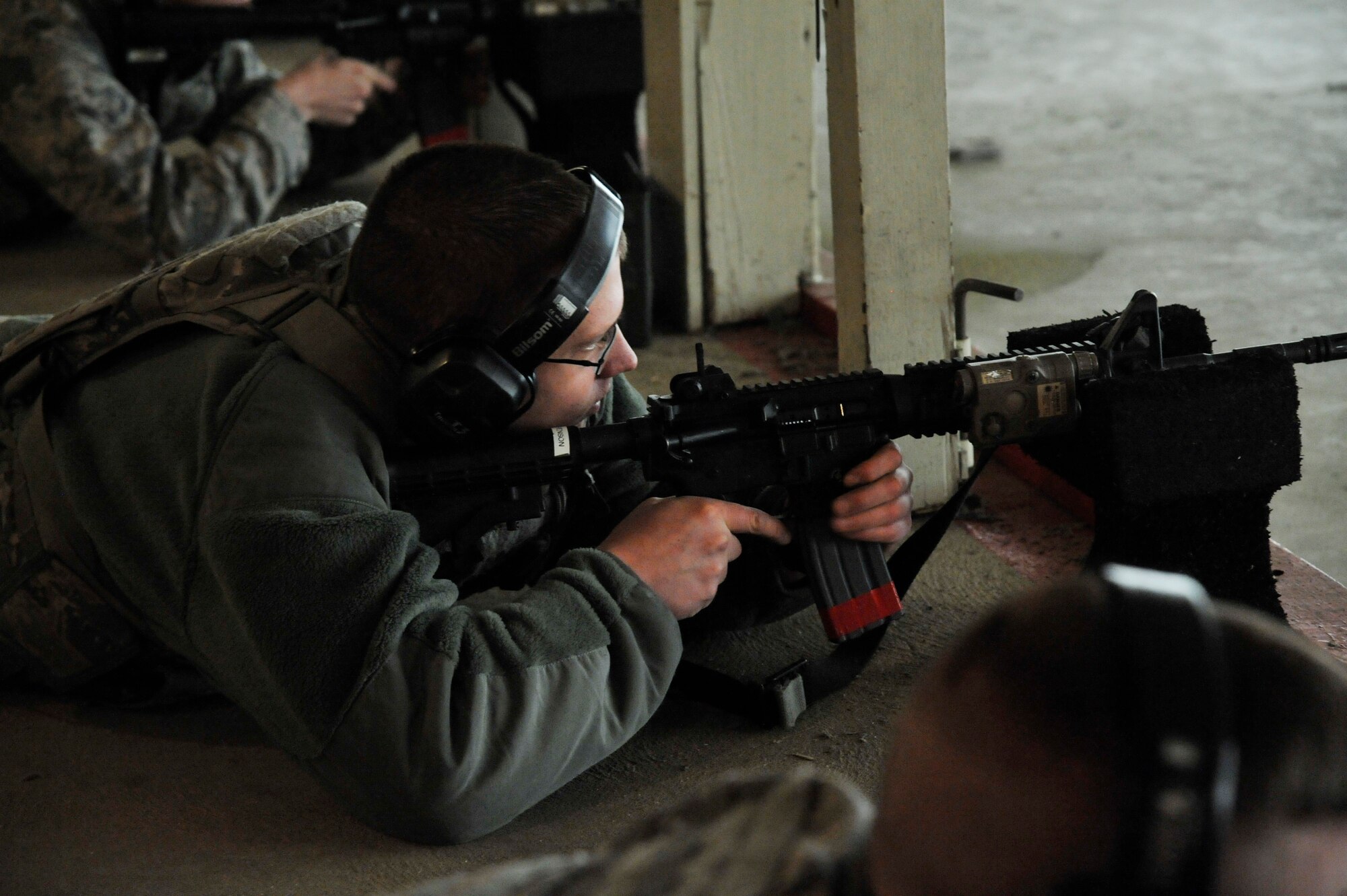 U.S. Air Force Airman 1st Class Henry Sorenson, 509th Security Forces Squadron member, fires an M4 during a combat arms training and maintenance course at Whiteman Air Force Base, Mo., Feb. 10, 2015. Prior to joining the air force, Sorenson spent eight weeks training at the Missionary Training Center while on a mission trip in Sao Paulo, Brazil. (U.S. Air Force photo by Senior Airman Keenan Berry/Released)