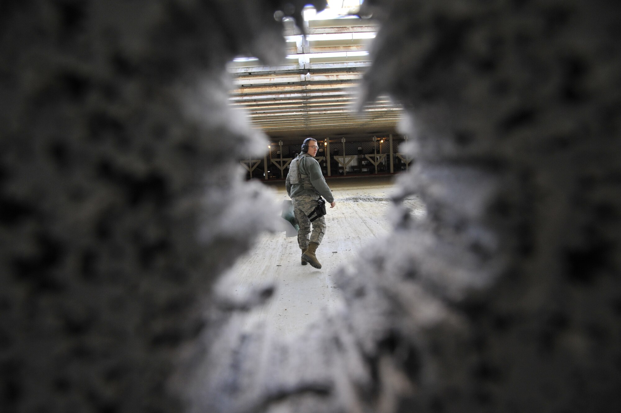 U.S. Air Force Airman 1st Class Henry Sorenson, 509th Security Forces Squadron member, walks away from a firing target during a combat arms training and maintenance course at Whiteman Air Force Base, Mo., Feb. 10, 2015. Sorenson is from Cedar City, Utah, and was raised as a member of the Church of Jesus Christ of Latter-day Saints. He was chosen to serve a mission in Brazil for two years before joining the Air Force. (U.S. Air Force photo by Senior Airman Keenan Berry/Released)