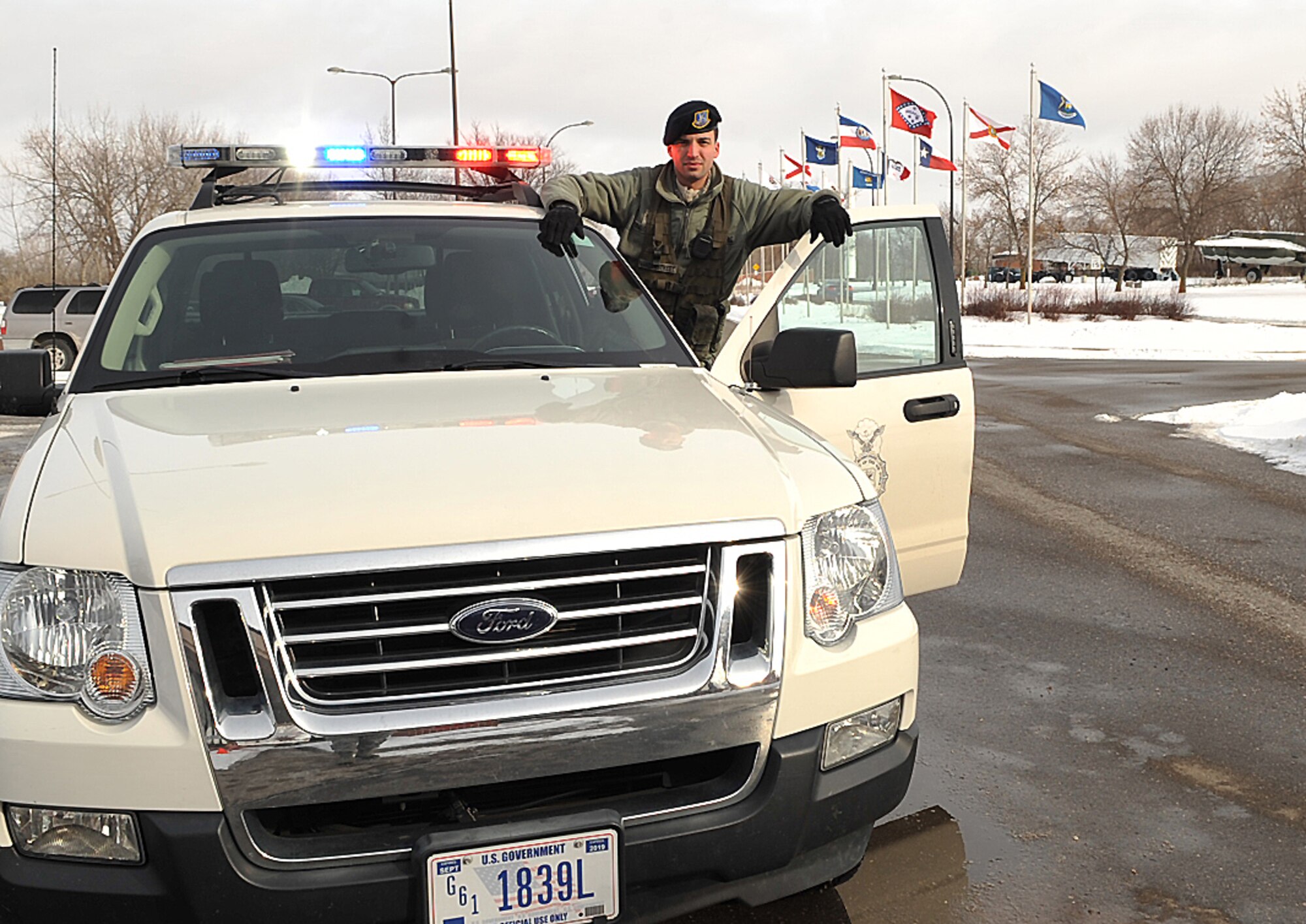 Airman 1st Class Eric Vanderstreet, 319th Security Forces Squadron patrolman/installation entry controller, demonstrates the lights on his patrol car Feb. 20, 2015, on Grand Forks Air Force Base, N.D. Vanderstreet was chosen as Warrior of the Week for the fourth week in February. (Airman 1st Class Bonnie Grantham)