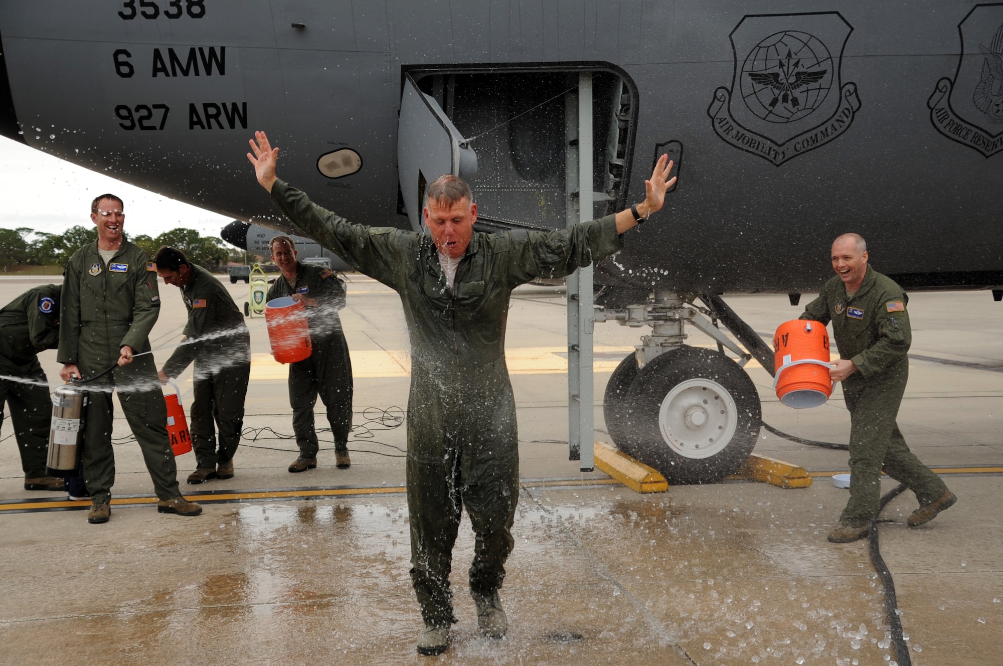 A shower of ice and water is something that most people don't relish, but that's exactly what was in store for Col. Larry Shaw. Upon landing at MacDill Air Force Base, Fla. on Feb. 26, with water jugs in hand, family, friends and co-workers doused the colonel with an icy shower, marking the end of his reign as commander of the 927th Operations Group. Water dousing is a time honored tradition that is conducted when a member of an aircrew completes their final flight with a unit. (U.S. Air Force photo/TSgt. Peter Dean)


