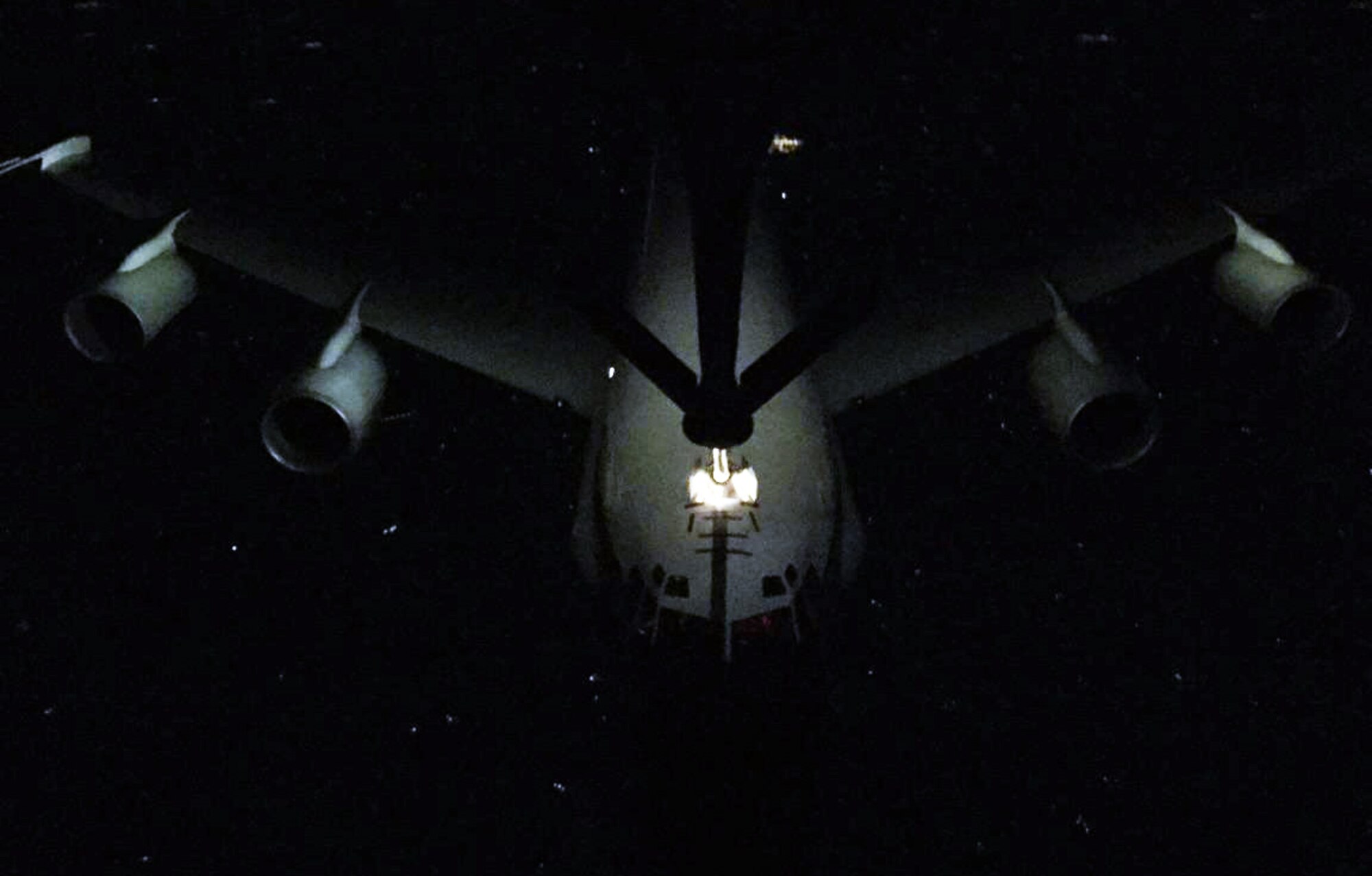 A RC-135 aircraft from the Offutt Air Force Base, Neb., is refueled by a KC-135 Stratotanker assigned to McConnell Air Force Base, Kan., during a night refueling exercise, Feb. 26, 2015. The KC-135 was operated by an aircrew made up of Air Force Reservists from the 18th Air Refueling Squadron, 931st Air Refueling Group, at McConnell.  Reserve aircrews at McConnell consistently conduct air refueling exercises in order to practice refueling procedures as well as maintain proficiency. (U.S. Air Force photo by Senior Master Sgt. Ray Lewis)
