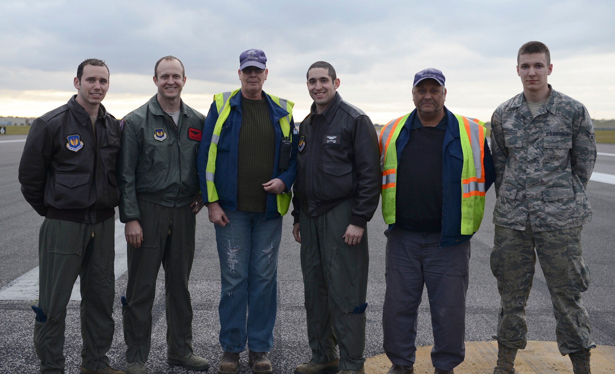 Pilots from the 494th Fighter Squadron coined Airmen from the 48th Civil Engineer Squadron for their hard work repairing a pothole on the flightline Feb. 25, 2015, at Royal Air Force Lakenheath, England. The achievement coin is given as a reward for outstanding service or performance of duty. (U.S. Air Force photo by Airman 1st Class Dawn M. Weber/Released)