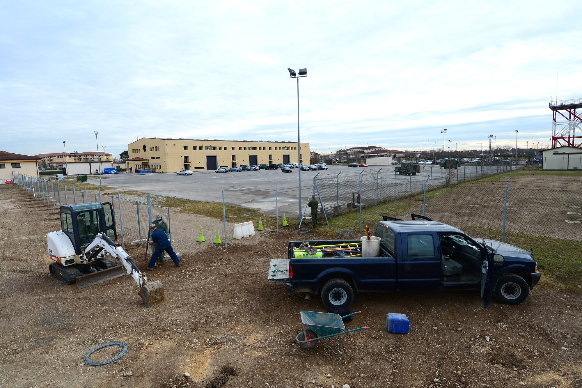U.S. Air Force Airmen with the 31st Civil Engineer Squadron pavement and construction flight, also known as the “Dirt Boys,” build a fence to separate the Wyvern Fitness Center from other buildings, Feb. 23, 2015, at Aviano Air Base, Italy. The unit has 13 Airmen responsible for several construction operations around base to include airfield sweeping, crane operations and snow removal. (U.S. Air Force photo by Senior Airman Matthew Lotz/Released)