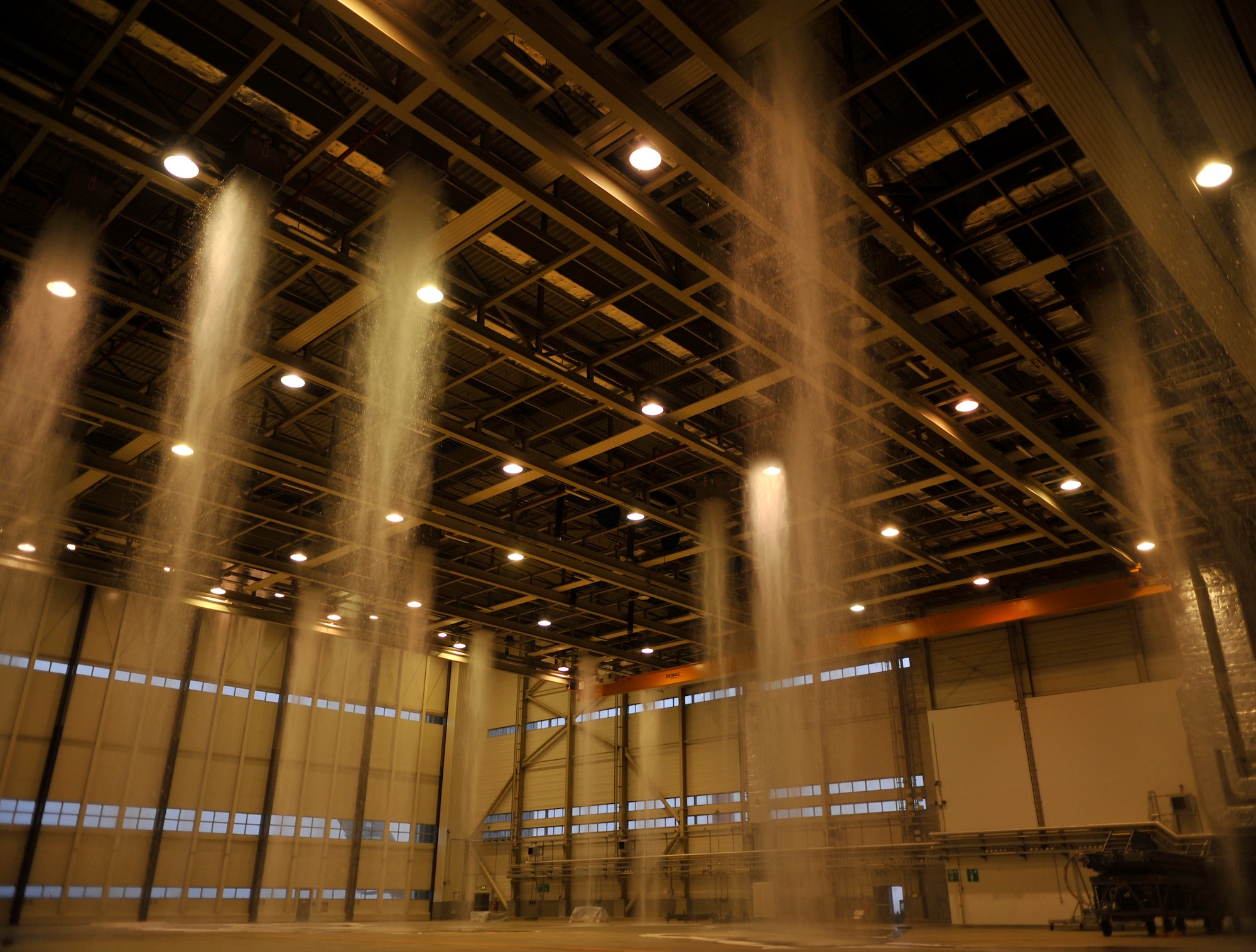 Water is emitted through foam generators during a biennial fire suppression system test, Feb. 19, 2015 at Ramstein Air Base, Germany. There are two water storage tanks, each of which takes approximately 26 minutes to empty and run through the drainage system. (U.S. Air Force photo/Airman 1st Class Larissa Greatwood)