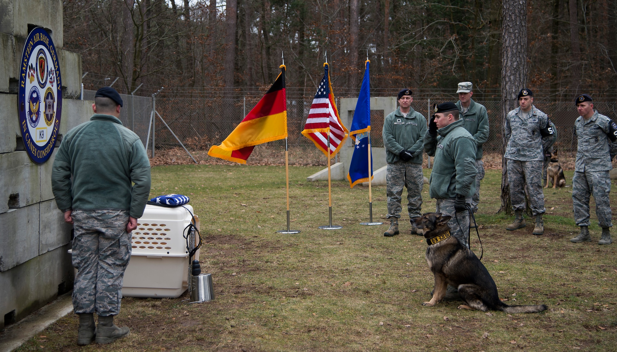 Staff Sgt. Bradley Beaty, 86th Security Forces Squadron K-9 handler and Omega, military working dog, pay their respects to Sano, an MWD who was recently put to rest, Ramstein Air Base, Germany, Feb. 24, 2015. The 86th SFS held a memorial ceremony to honor Sano’s eight years of service to the Air Force. (U.S. Air Force photo/Senior Airman Damon Kasberg)