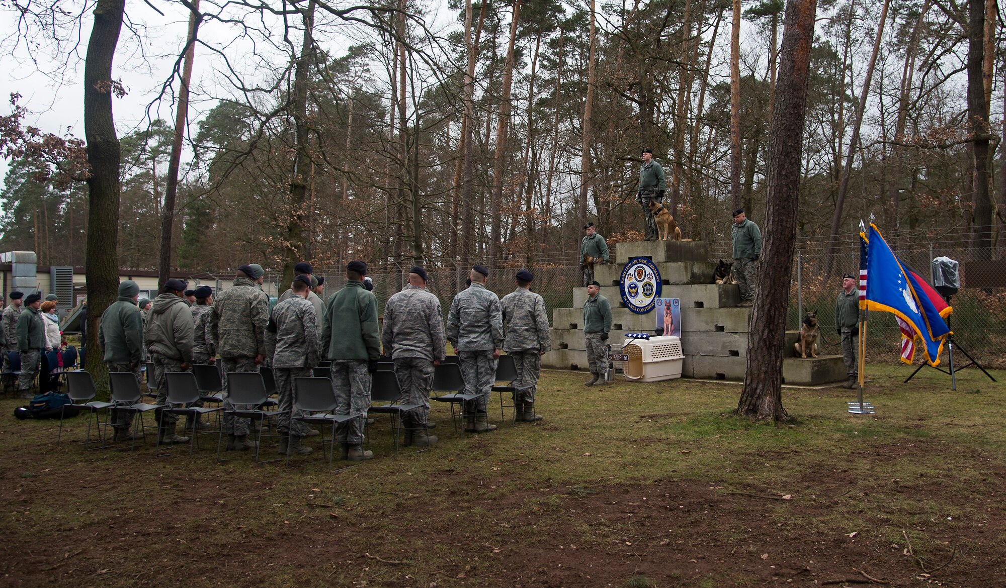 Attendees of a memorial service stand in honor of Sano, 86th Security Forces Squadron military working dog, who was recently put to rest, Ramstein Air Base, Germany, Feb. 24, 2015. Sano served with the 86th SFS for seven years as an explosive ordnance detection K-9, conducting over 300,000 hours of detection throughout the Kaiserslautern Military Community. (U.S. Air Force photo/Senior Airman Damon Kasberg)