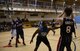 Dillan Knott, 51st Force Support Squadron, prepares to pass the ball to Mercedes Lacy, 51st SFS, in the post during the second half of an intramural basketball game Feb. 24, 2015, at Osan Air Base, Republic of Korea. Lacy was unable to score on the possession. (U.S. Air Force photo by Senior Airman David Owsianka)