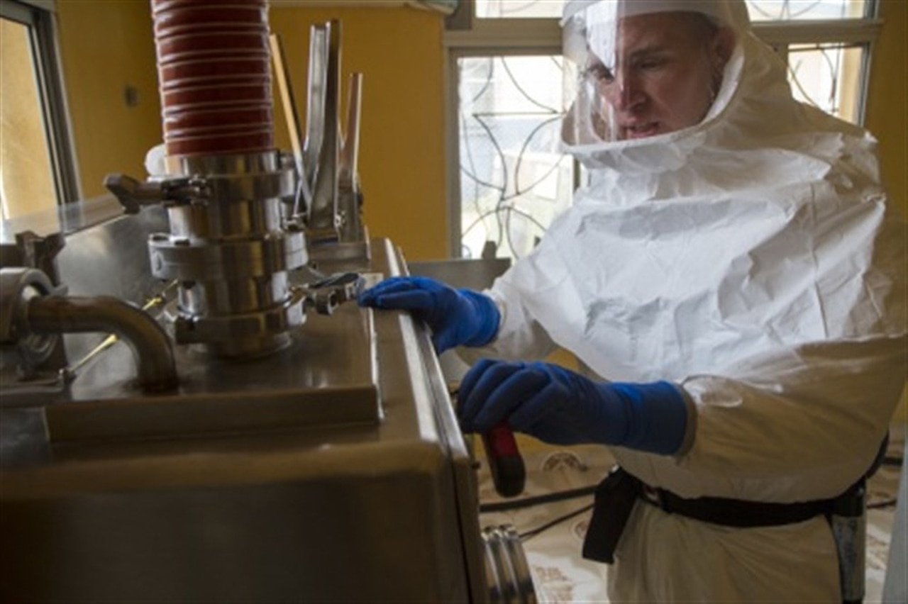 Army Capt. Shawn Palmer, a biochemist with the 1st Area Medical Laboratory, based out of Aberdeen Proving Ground, Md., and a native of Loma, Colo., breaks down a biological safety-level 3 glove box at the 1st AML’s Ebola testing lab in Zwedru, Liberia, Feb. 9, 2015. The glove box is built to provide maximum personnel and environmental protection from high-risk biological agents. Soldiers of the 1st AML used this equipment to test blood samples of suspected Ebola patients. This, along with other equipment, was decontaminated and packed away as 1st AML closed the Zwedru lab. U.S. Army photo by Staff Sgt. Terrance D. Rhodes, Joint Forces Command, United Assistance Public Affairs