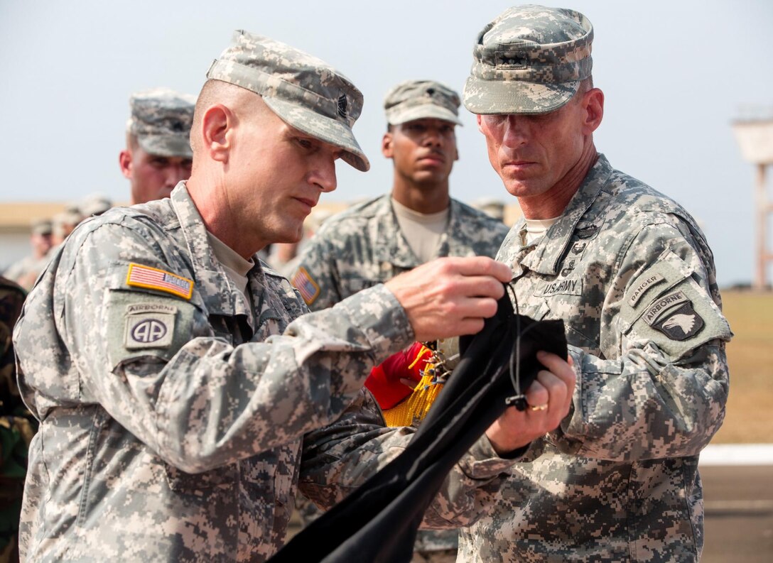 Army Command Sgt. Maj. Gregory Nowak, left, senior enlisted advisor for Joint Forces Command - United Assistance and 101st Airborne Division (Air Assault), and Army Maj. Gen. Gary J. Volesky, commander of JFC-UA and the 101st, case their unit colors during a ceremony held at the Barclay Training Center, Monrovia, Liberia, Feb. 26, 2015. U.S Army photo by Spc. Rashene Mincy
