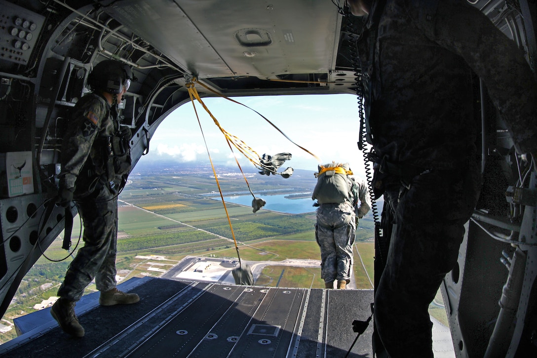Paratroopers jump from a CH-47 Chinook helicopter during a static line airborne operation over Homestead Air Reserve Base, Fla., Feb. 25, 2015. This operation allowed paratroopers to maintain airborne proficiency and mission readiness for any contingency response in the unit's area of responsibility, which spans from the Caribbean to Central and South America.