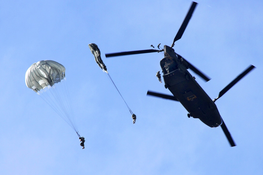 Paratroopers jump from the back of a CH-47 Chinook helicopter during a static line airborne operation over Homestead Air Reserve Base, Fla., Feb. 25, 2015.