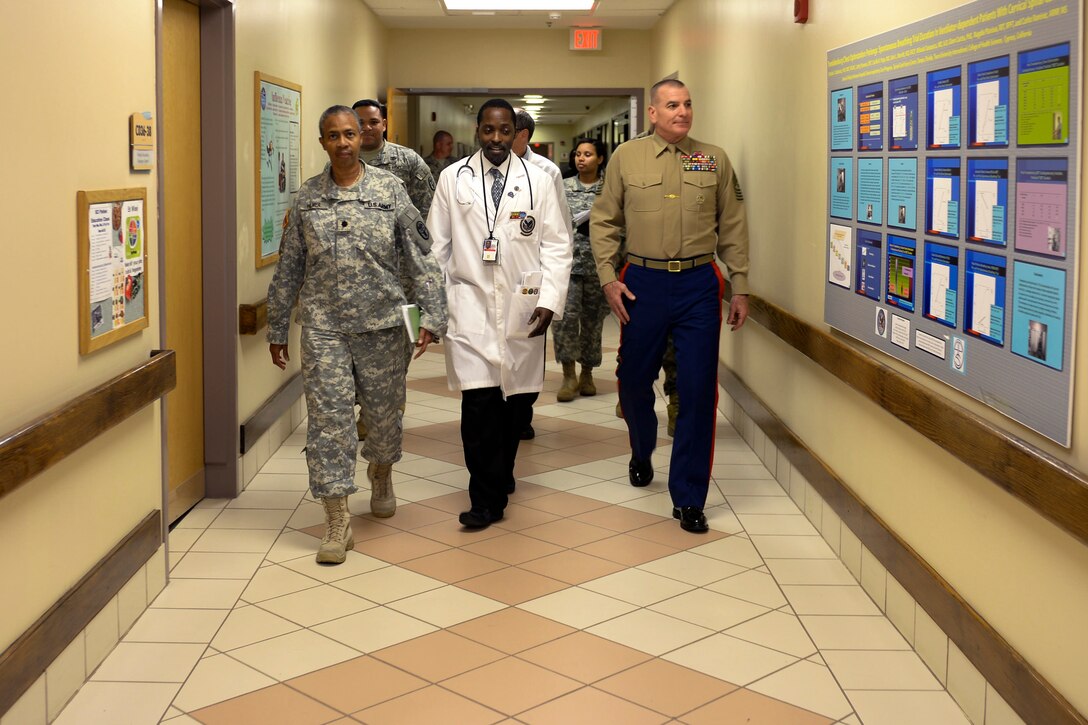 Marine Corps Sgt. Maj. Bryan Battaglia, right, senior enlisted advisor to the chairman of the Joint Chiefs of Staff, talks with service members and doctors at the James A. Haley Veterans' Hospital in Tampa, Fla., Feb. 25, 2015.