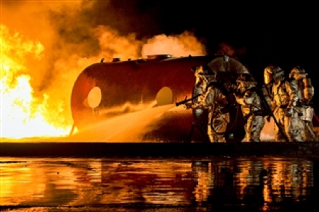 U.S. Marines use water to extinguish a fuel fire during live-burn training on Marine Corps Air Station Futenma in Okinawa, Japan, Feb. 21, 2015.  The Marines are assigned 9th Engineer Support Battalion, 3rd Marine Logistics Group, 3rd Marine Expeditionary Force. 

