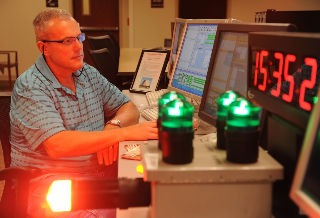 Brian Boudreaux, 81st Training Support Squadron software developer, uses an upgraded early warning standalone trainer to generate events for student qualification training Feb. 23, 2015, at the Trainer Development Center, Keesler Air Force Base, Mississippi. (U.S. Air Force photo by Kemberly Groue)