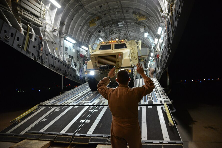 Airmen from the 386th Expeditionary Operations Group and the 386th Expeditionary Logistics Readiness Squadron, load two Mine Resistant Armored Personnel carriers on a C-17 Globemaster III bound for Erbil, Iraq, Dec. 30, 2014. The MRAPs are for the Iraqi Security Forces and Peshmerga to aid in the fight against Daish.(U.S. Air Force photo by Tech. Sgt. Jared Marquis/released)