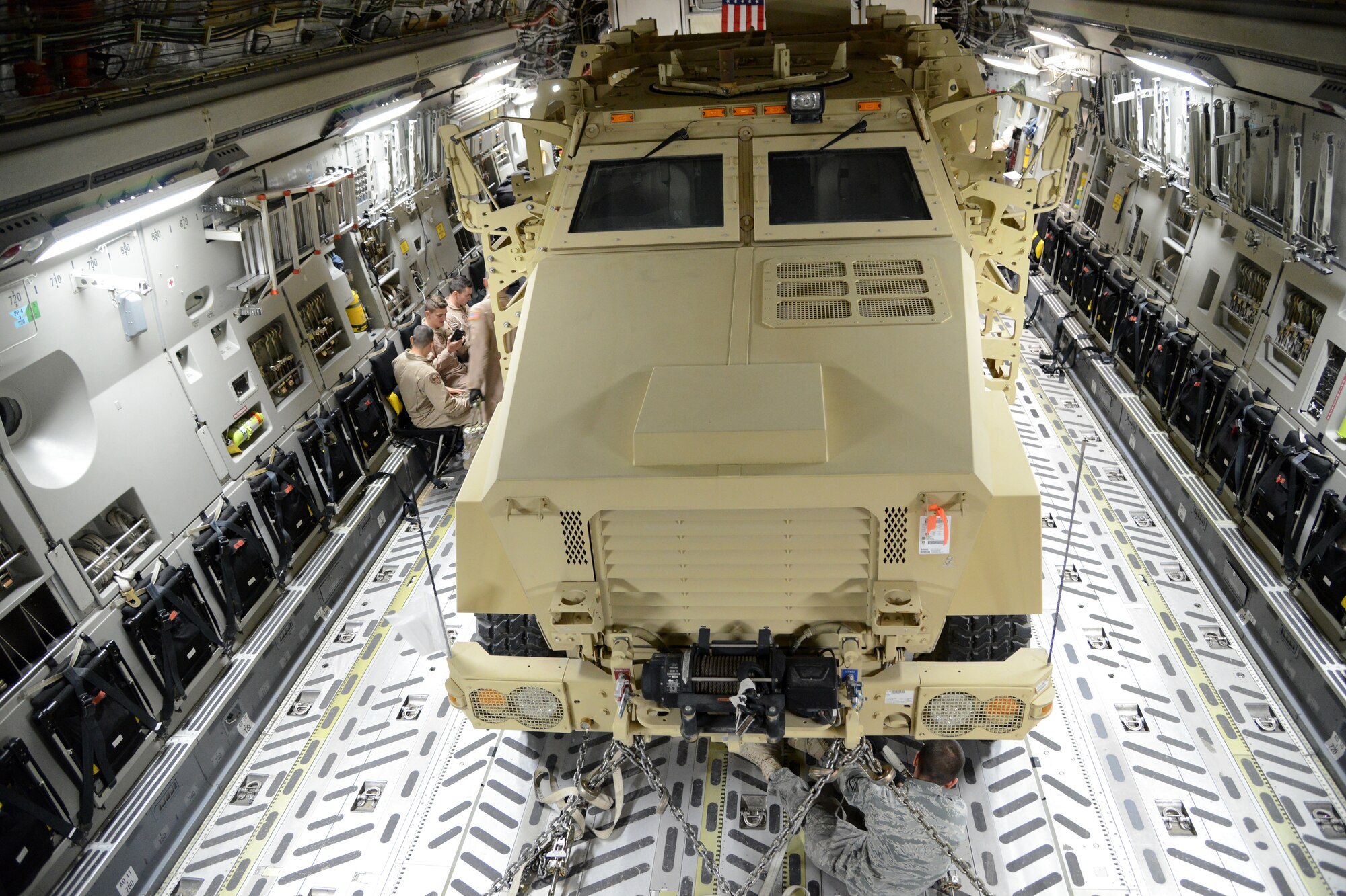 Airmen from the 386th Expeditionary Operations Group and the 386th Expeditionary Readiness Logistics Squadron, load two Mine Resistant Armored Personnel carriers on a C-17 Globemaster III bound for Erbil, Iraq, Dec. 30, 2014. The MRAPs are for the Iraqi Security Forces and Peshmerga to aid in the fight against Daish. (U.S. Air Force photo by Tech. Sgt. Jared Marquis/released)