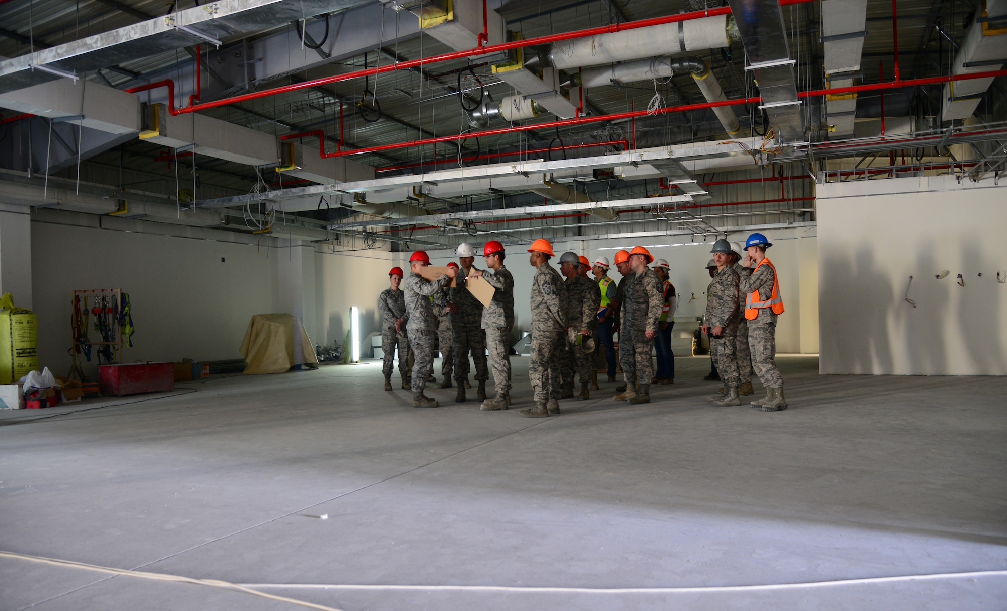 Airmen assigned to the 379th Expeditionary Maintenance Squadron Precision Measurement Equipment Laboratory shop give leadership from the379th Air Expeditionary Wing a tour of the new PMEL facility here, Dec. 29, 2014, at Al Udeid Air Base, Qatar. The new PMEL facility will provide a more stable environment and additional workspace for PMEL Airmen, allowing for increased measurement and calibration capability. (U.S. Air Force photo by Senior Airman Kia Atkins)
