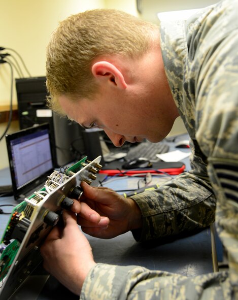 U.S. Air Force Staff Sgt. Kc Berger, 379th Expeditionary Maintenance Squadron Precision Measurement Equipment Laboratory craftsman, troubleshoots a component malfunction, Dec. 31, 2014, at Al Udeid Air Base, Qatar. The 379th EMXS’s PMEL Centralized Intermediate Repair Facility is the only shop in Air Forces Central Command’s area of responsibility. (U.S. Air Force photo by Senior Airman Kia Atkins)