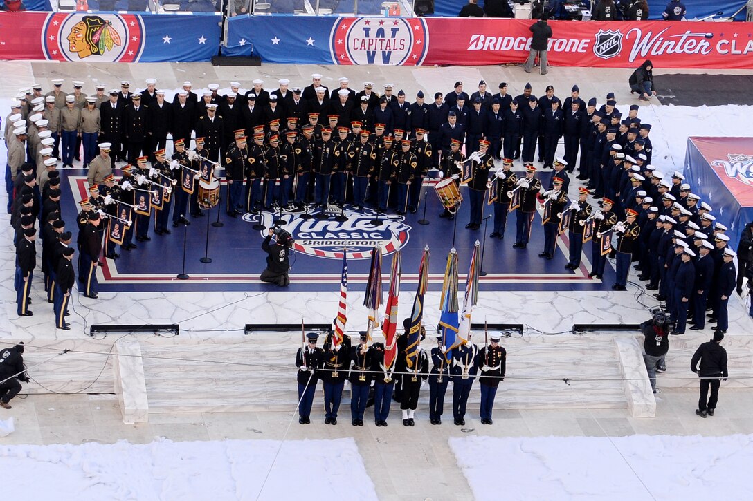 The U.S. Armed Forces Color Guard, the U.S. Army Chorus and U.S. Army Herald Trumpets, along with other service members, take part in the 2015 Bridgestone NHL Winter Classic hockey game in Nationals Park, Washington, D.C., Jan. 1, 2015. The game honored service members and also featured Army Master Sgt. Bob McDonald and Master Sgt. Caleb Green singing the National Anthem and a flyover by the D.C. Air National Guard's 113th Wing.