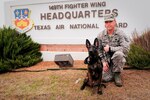 Tech. Sgt. Brandon M. Harrist, an aircraft electrical and environmental systems craftsman assigned to the 149th Maintenance Squadron, Texas Air National Guard with DDexter, a military working dog in training, which he is fostering as part of the Department of Defense’s Military Working Dog Breeding Program, at Joint Base San Antonio–Lackland, Texas, Nov. 20, 2014.